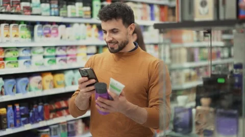 Young man scanning QR code on care products Stock Footage 342722392