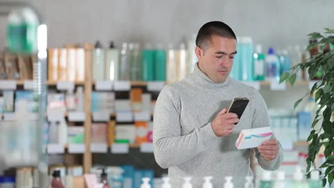 Young man scanning qr code of pills Stock Footage 343278963