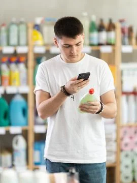 Young man scanning qr code for dishwashing Stock Photos