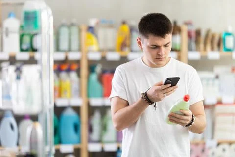 Young man scanning qr code for dishwashing Stock Photos