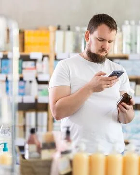 Young man scanning qr code of syrup Stock Photos