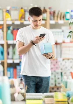 Young man scanning qr code for feminine pads Photos
