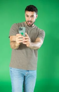 Young man scans QR code or takes photo, he saves important information on his Foto stock