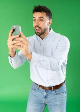 Young man scans QR code or takes photo, he saves important information on his Foto stock