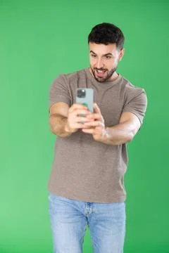 Young man scans QR code or takes photo, he saves important information on his Stock-Fotos