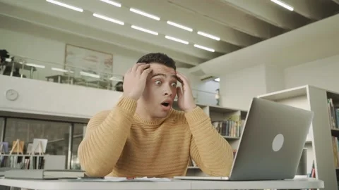 Young man scared or shocked by something he saw on the internet. Reaction when Stock Footage 154276965