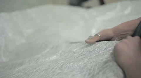 Young man scissor material Stock Footage 68067416