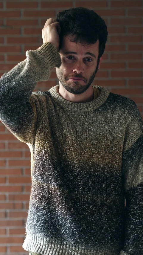 Young man scratching head looking confused and thoughtful expression Video stock 332777811