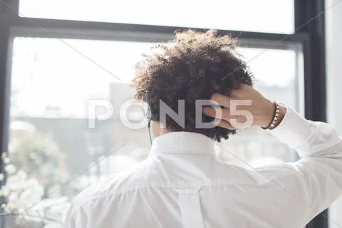 Young Man Scratching Head, Rear View