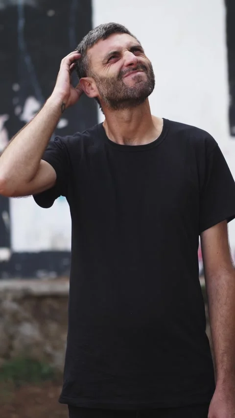 Young Man Scratching His Head in Confusion in the Park Stock Footage 295143467