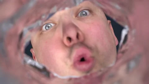A young man screams into the empty package and waits for an answer. The man is Stock-Footage 232733684