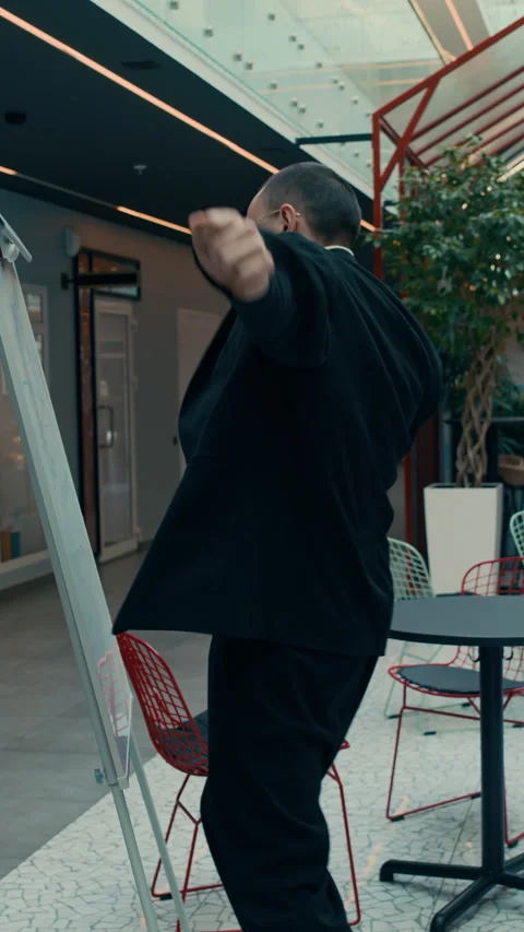 Young Man Scribbling on Flipchart while Dancing at Workplace Video stock 285831137
