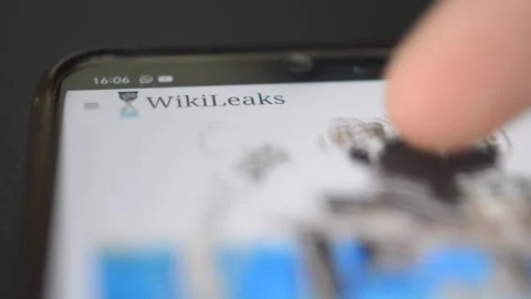 Young man scroll wikileak website on iphone. wikileak by Assange Stock Footage 265470685