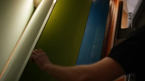 Young man scrolling through colour fan Stock Footage 100812735