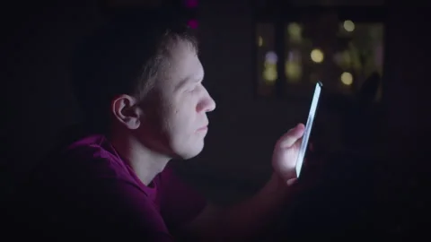 Young man scrolling through the internet on a smartphone Stock Footage 310560554
