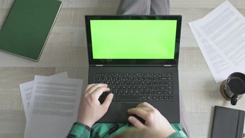Young man scrolling through websites on his laptop with green screen Stock Footage 142766579