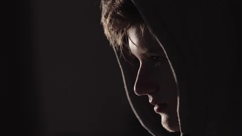Young man seating in front of big screen in the dark room with warm light . Web 動画素材 95752000
