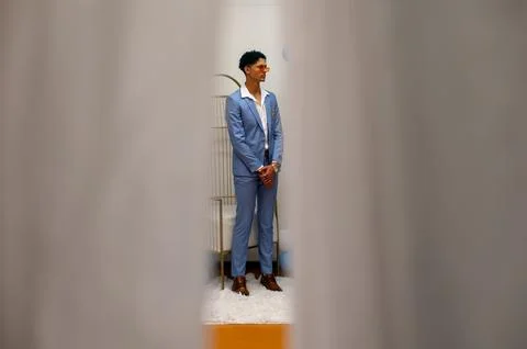 Young man seen through view of curtain Photos