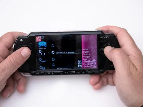 Young man selecting language within the menu of the famous Sony PSP Stock Photos