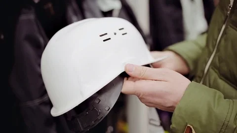 Young man selecting white construction helmet in a hardware store close up Stock Footage 73603888