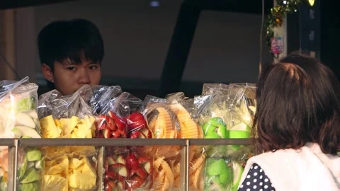 A young man sell chilled fruit in a kiosk on the street Stock Footage 273665683