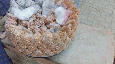 Young Man Selling Roasted Groundnut Bambaranut Sesame and Tigernut Seeds Stock Footage 320057506