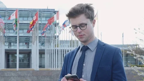 Young man sending sms and using phone Video stock 79025063