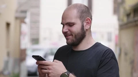 Young man sending an SMS, concentrated expression Stock Footage 303520883