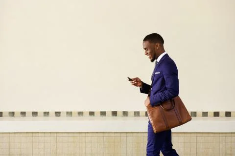 Young man sending text message on his mobile phone Stock Photos