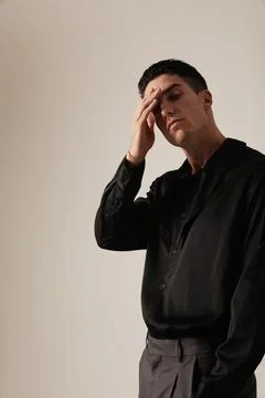Young man with serious expression and ideas, looking at the camera. Mindset. Photos