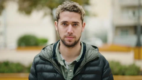 Young man with serious expression standing at street Stock Footage 172053727