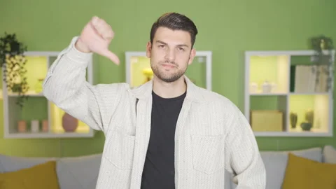 Young man seriously looking at camera making negative sign with his hand.  Stock Footage 232216941