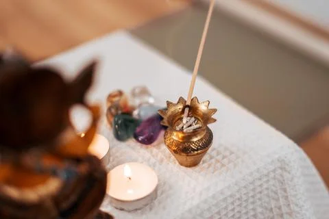 A young man sets fire to the candle and puts it on the altar for meditation. Stock Photos