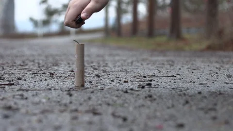 The young man sets fire to new year firecrackers Stock Footage 100542929