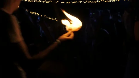 A young man sets fire to a paper and lights a fire. A fire broke out. The man Stock Footage 73685016