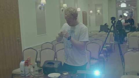 Young Man Setting Up Audio Visual Equipment in Event Room 動画素材 341917969