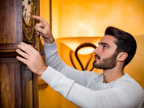 Young man setting clock Stock Photos