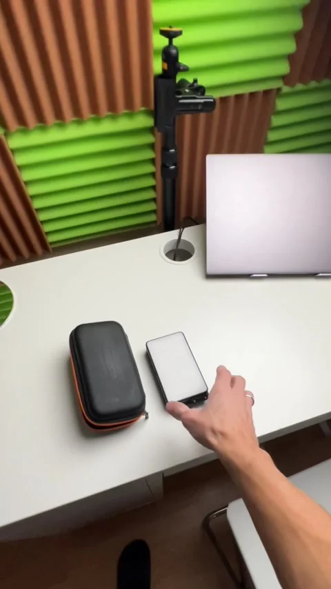 A young man is setting up his studio to shoot a video. Includes lights, camera,  Stock Footage 259500173