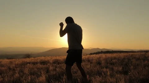 Young Man Shadow Boxing On a Beautiful Sunset Stock Footage 55848099