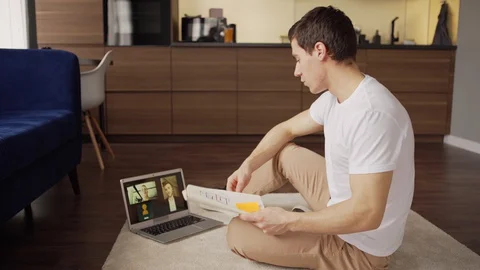 Young man sharing ideas with business partners from home Stock Footage 128760134