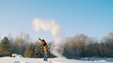 The young man with a sharp wave of his hand splashes hot water out of the cup. Stock Footage 146630543