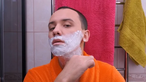 Young man shaving in the bathroom. Stock Footage 122913552