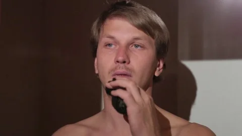 Young man shaving in front of the mirror. Stock Footage 76116840