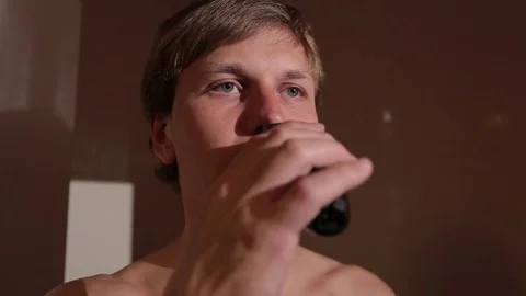 Young man shaving in front of the mirror. Stock Footage 76117165