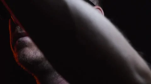 Young man shaving his face with a trimmer for shaving Video stock 308537863