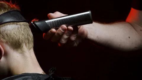Young man shaving his face with a trimmer for shaving Video stock 308537896