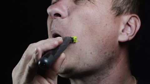 Young man shaving his face with a trimmer for shaving Stock Footage 308537900