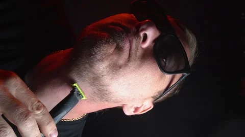 Young man shaving his face with a trimmer Stock Footage 308538103