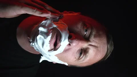 Young man shaving his face with white foam Stock Footage 308538147