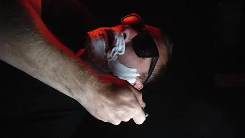 Young man shaving his face with white foam Stock Footage 308538167